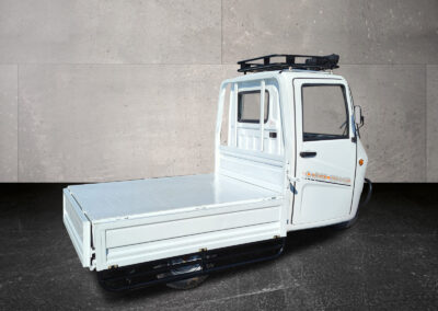 Dreiviertel-Heckansicht links mit leerer Ladefläche des Voltina in Weiß